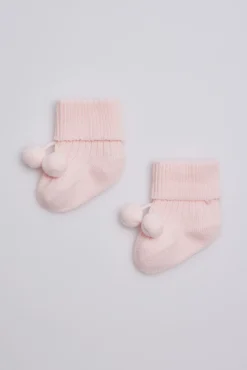 Calcetines canalé con borlas recién nacido rosa