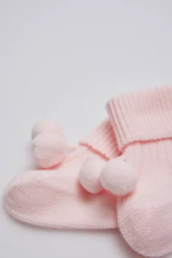Calcetines canalé con borlas recién nacido rosa